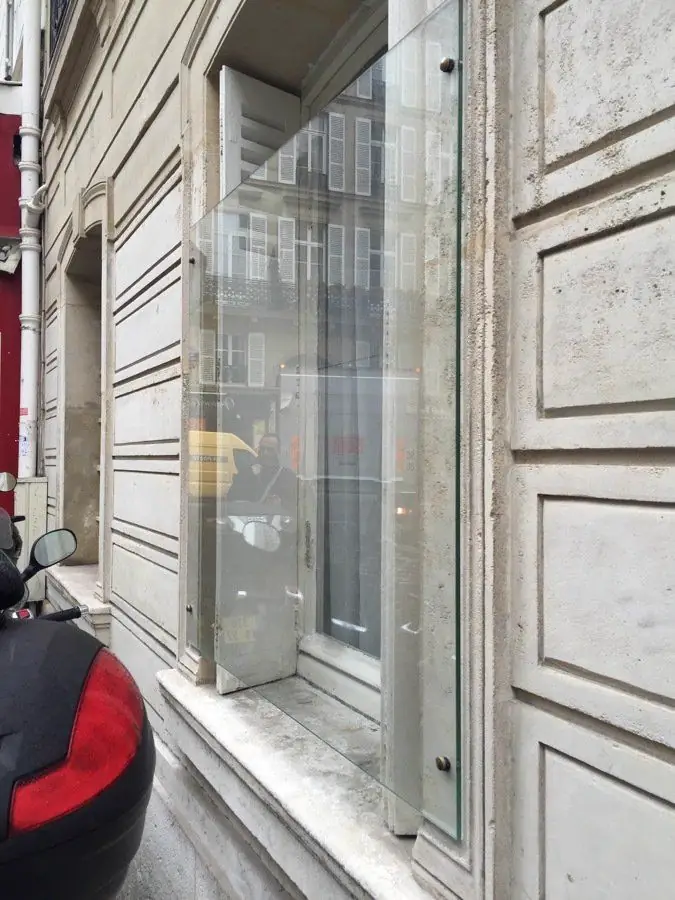 Vitrage de protection posé devant une fenêtre de rez-de-chaussée, façade en pierre